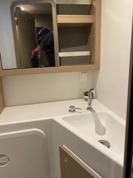 Slide: The Image of 2024 Lagoon 42 bathroom with modern sink and mirror. - 17