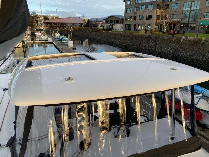 Slide: The Image of 2024 Lagoon 42 catamaran docked at a marina with clear weather. - 26