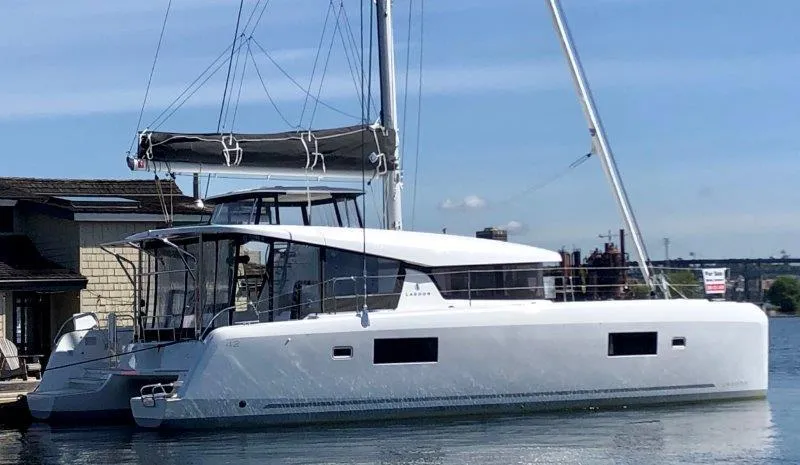 Slide: The Image of 2024 Lagoon 42 catamaran docked at a marina. - 34