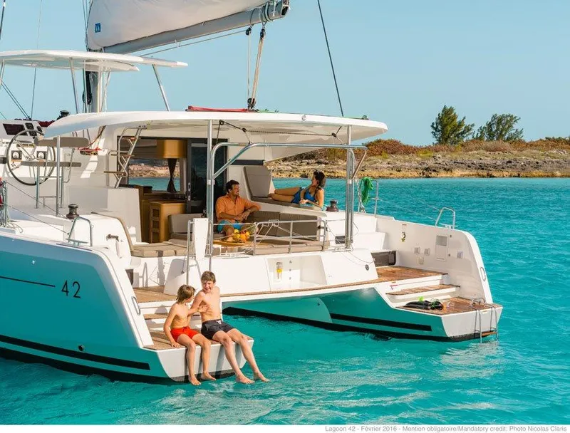 Slide: The Image of 2024 Lagoon 42 catamaran with family enjoying the water. - 40