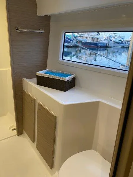 Slide: The Image of Modern bathroom interior of 2024 Lagoon 42 yacht with marina view. - 11