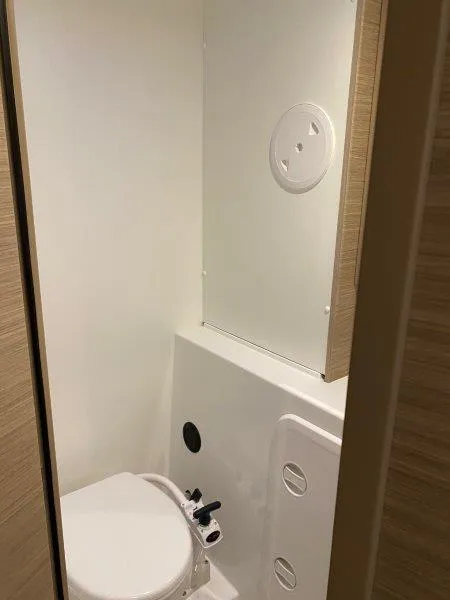 Slide: The Image of 2024 Lagoon 42 yacht bathroom with modern fixtures and compact design. - 18