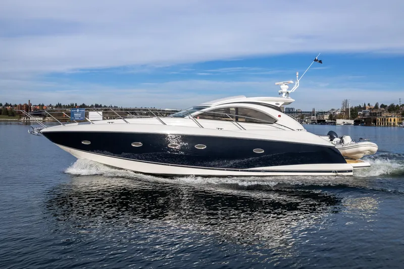 Slide: The Image of 2007 Sunseeker Portofino 47 yacht cruising on a calm waterway. - 0