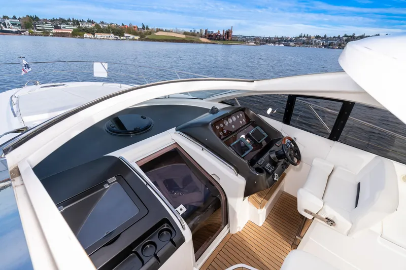 Slide: The Image of 2007 Sunseeker Portofino 47 yacht cockpit with modern navigation equipment and waterfront view. - 14