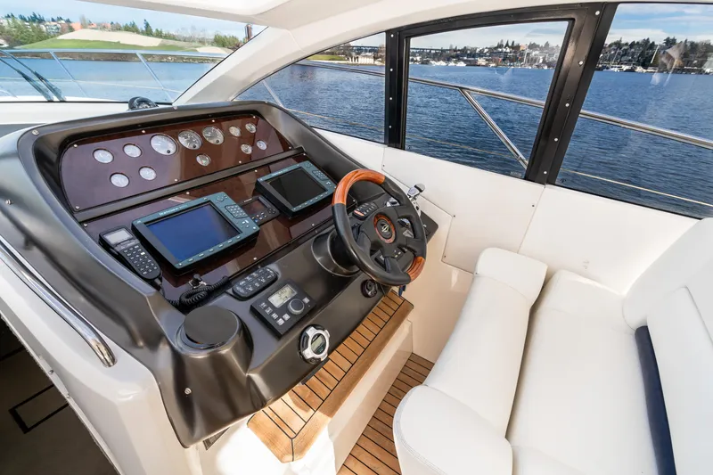 Slide: The Image of 2007 Sunseeker Portofino 47 yacht helm with navigation instruments and waterfront view. - 17