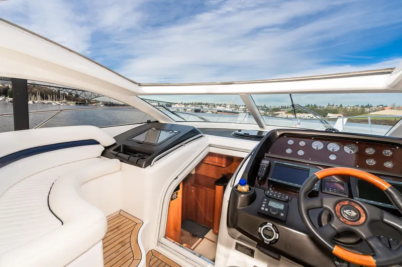 Slide: The Image of 2007 Sunseeker Portofino 47 yacht cockpit with modern navigation controls and panoramic view. - 18