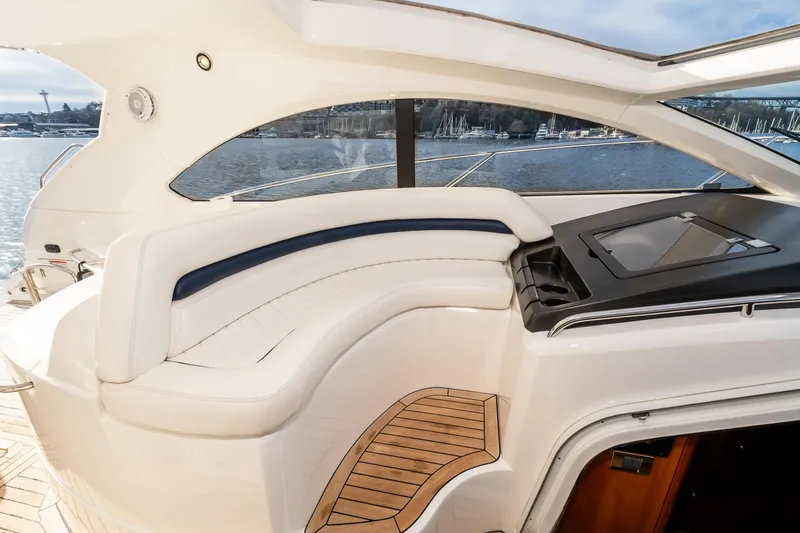 Slide: The Image of 2007 Sunseeker Portofino 47 yacht interior with white leather seating and wooden flooring. - 19