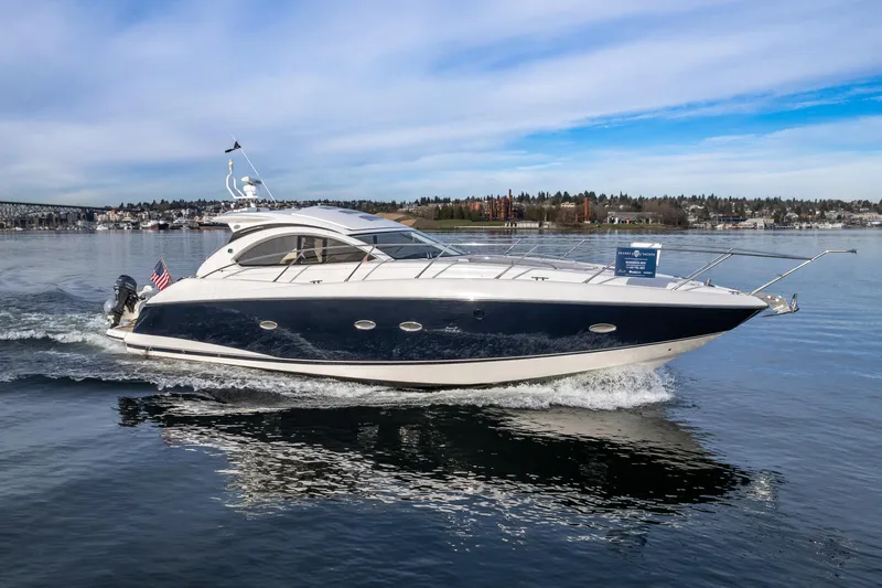 Slide: The Image of 2007 Sunseeker Portofino 47 yacht cruising on a calm lake. - 2