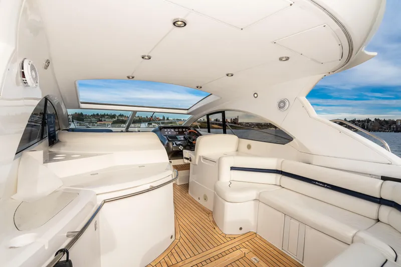 Slide: The Image of Luxurious interior of 2007 Sunseeker Portofino 47 yacht with white seating and wooden flooring. - 20