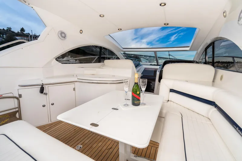 Slide: The Image of Luxurious interior of 2007 Sunseeker Portofino 47 yacht with champagne on table. - 21