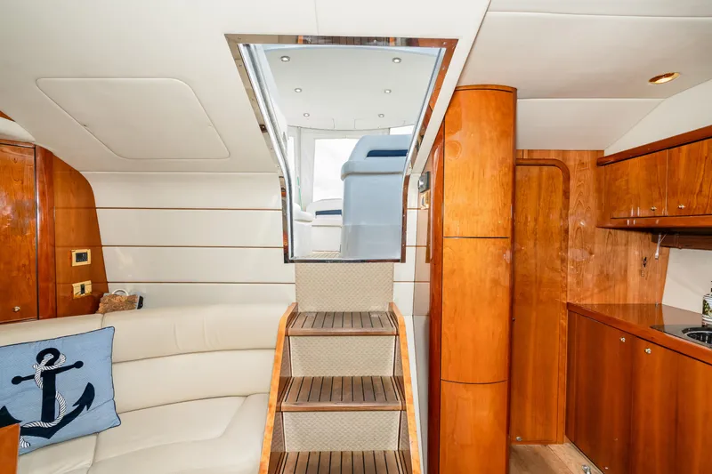 Slide: The Image of Interior of 2007 Sunseeker Portofino 47 yacht with wooden stairs and seating area. - 29