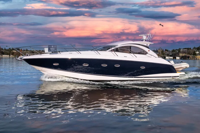 Slide: The Image of 2007 Sunseeker Portofino 47 yacht cruising at sunset on calm waters. - 3
