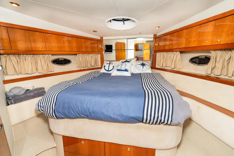 Slide: The Image of Luxurious bedroom interior of 2007 Sunseeker Portofino 47 yacht with nautical-themed bedding. - 41
