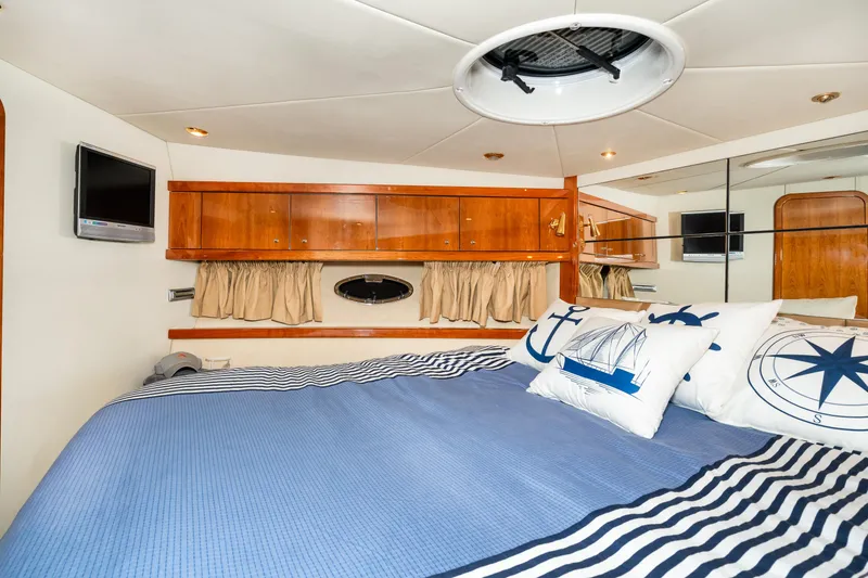 Slide: The Image of Luxurious bedroom in a 2007 Sunseeker Portofino 47 yacht with nautical-themed decor. - 45