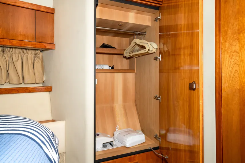 Slide: The Image of Open wooden closet in 2007 Sunseeker Portofino 47 yacht cabin. - 47