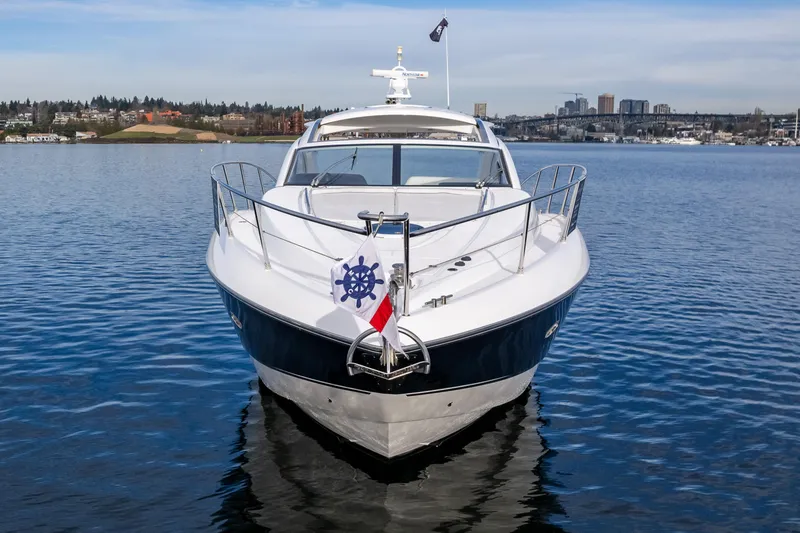 Slide: The Image of 2007 Sunseeker Portofino 47 yacht on calm water with city skyline in background. - 5
