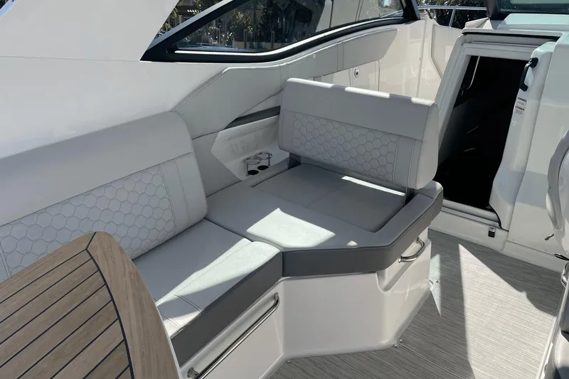 Slide: The Image of 2024 Sea Ray Sundancer 320 Outboard interior with sleek seating and modern design. - 10