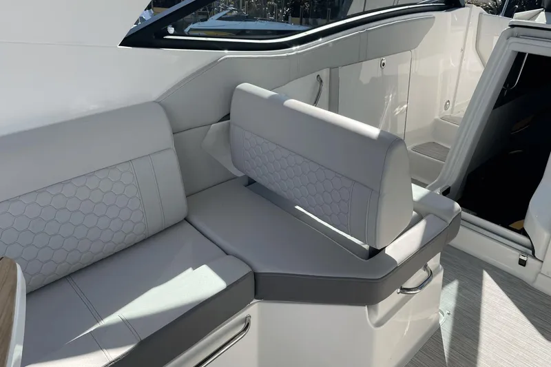 Slide: The Image of 2024 Sea Ray Sundancer 320 Outboard interior with sleek, modern seating design. - 11