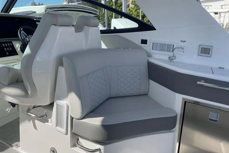 Slide: The Image of 2024 Sea Ray Sundancer 320 Outboard interior with plush seating and modern amenities. - 12