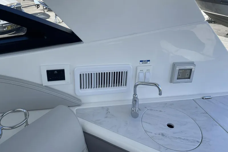 Slide: The Image of 2024 Sea Ray Sundancer 320 Outboard interior with sink and control panel. - 15