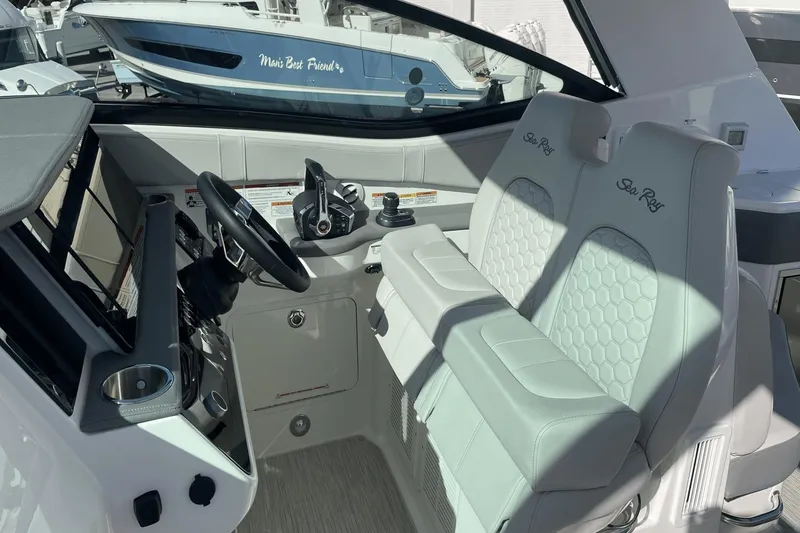 Slide: The Image of 2024 Sea Ray Sundancer 320 Outboard cockpit with dual seats and modern controls. - 17