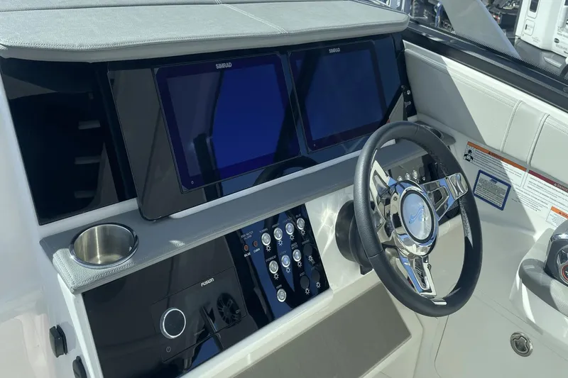 Slide: The Image of 2024 Sea Ray Sundancer 320 Outboard helm with dual displays and modern steering wheel. - 19