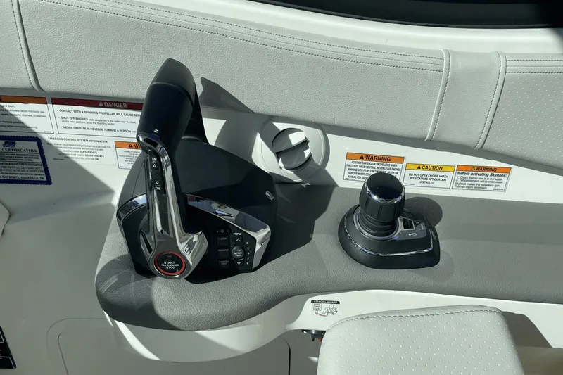 Slide: The Image of 2024 Sea Ray Sundancer 320 Outboard control panel with throttle and joystick. - 20
