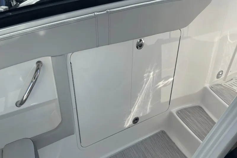Slide: The Image of 2024 Sea Ray Sundancer 320 Outboard interior detail with sleek white finish and stainless steel handle. - 22