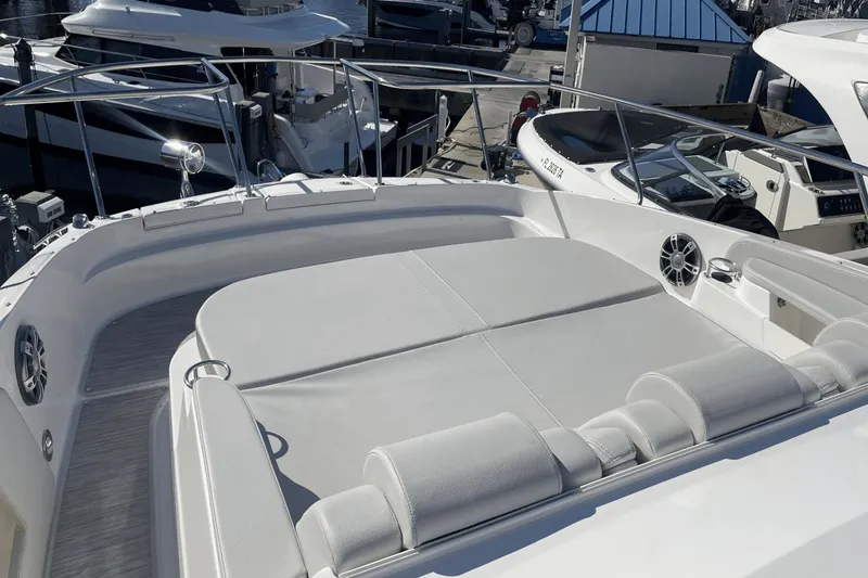 Slide: The Image of 2024 Sea Ray Sundancer 320 Outboard boat with spacious sunbathing deck at marina. - 24