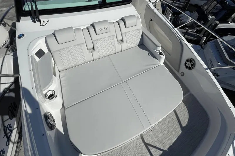 Slide: The Image of 2024 Sea Ray Sundancer 320 Outboard's luxurious seating area with elegant upholstery and cup holders. - 25
