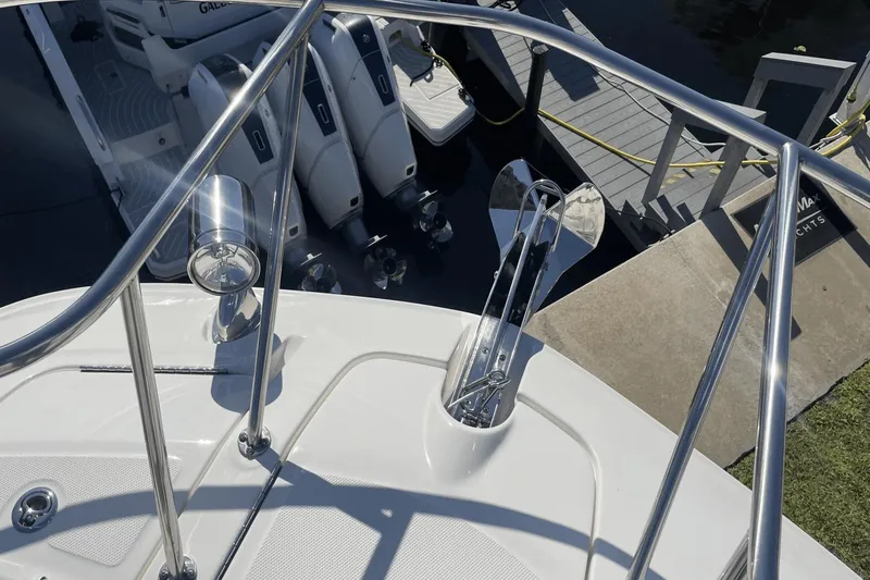 Slide: The Image of 2024 Sea Ray Sundancer 320 Outboard, featuring sleek deck and powerful engines at dock. - 27