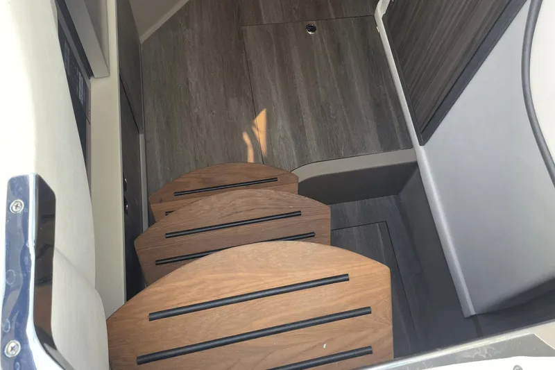 Slide: The Image of 2024 Sea Ray Sundancer 320 Outboard interior stairs with wood finish. - 29