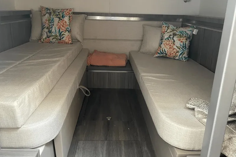 Slide: The Image of 2024 Sea Ray Sundancer 320 Outboard cabin with twin beds and floral pillows. - 33