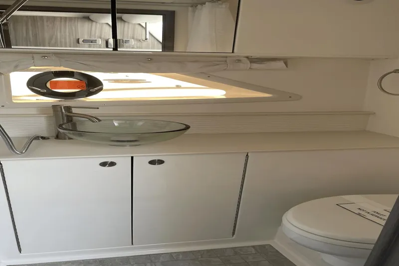 Slide: The Image of 2024 Sea Ray Sundancer 320 Outboard bathroom with modern sink and toilet. - 35