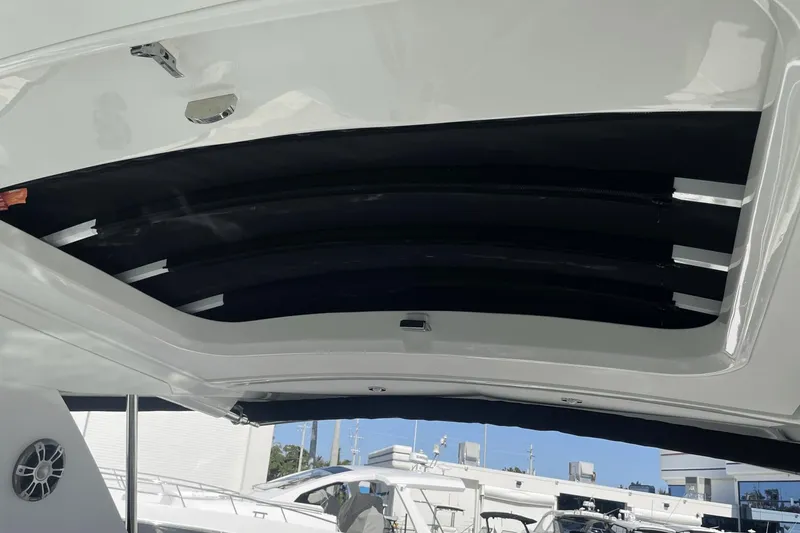 Slide: The Image of 2024 Sea Ray Sundancer 320 Outboard, interior view with open sunroof and sleek design. - 36