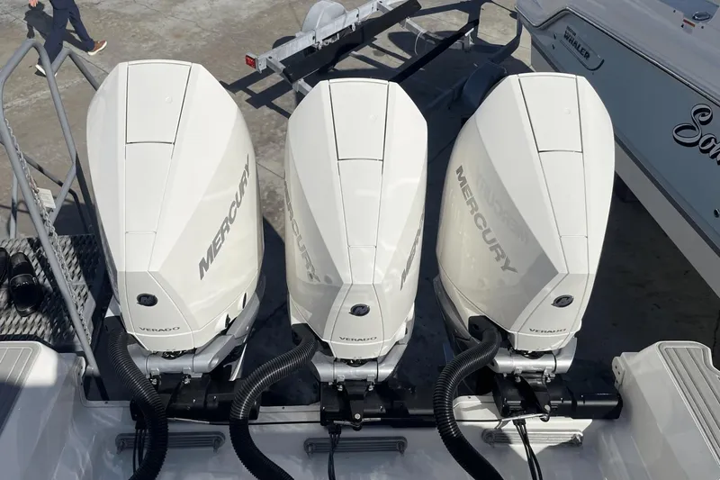 Slide: The Image of 2024 Sea Ray Sundancer 320 Outboard with triple Mercury Verado engines, docked at marina. - 37