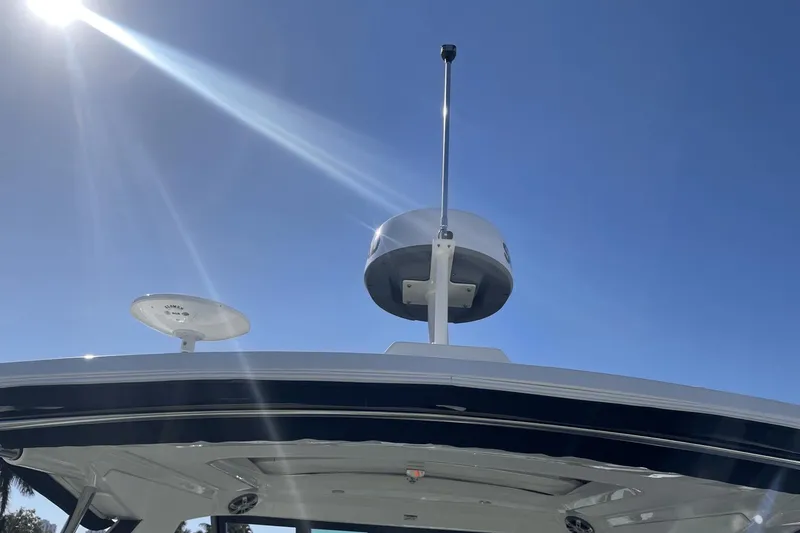 Slide: The Image of 2024 Sea Ray Sundancer 320 Outboard radar and antenna under clear blue sky. - 38