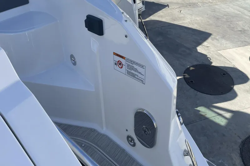 Slide: The Image of 2024 Sea Ray Sundancer 320 Outboard boat detail, showing deck and safety label. - 5