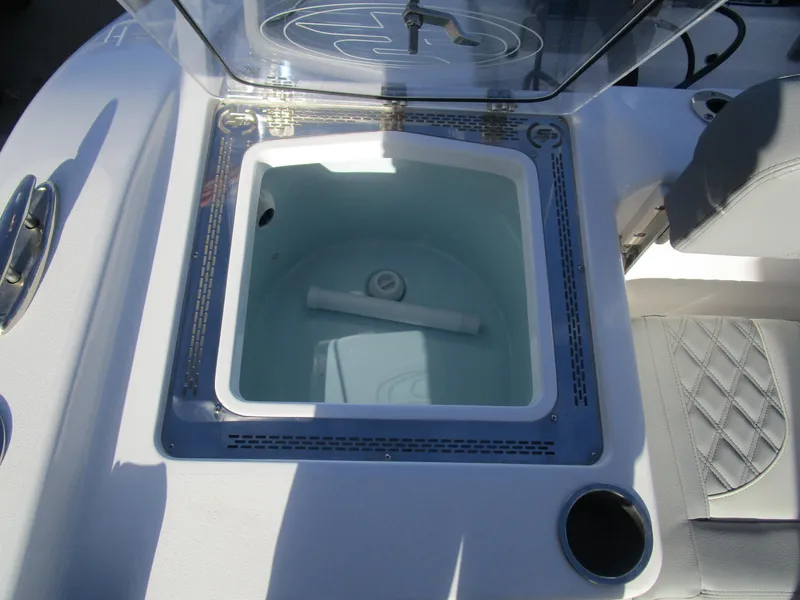 Slide: The Image of 2024 Sea Pro 322 Offshore livewell with open lid and seating area. - 13