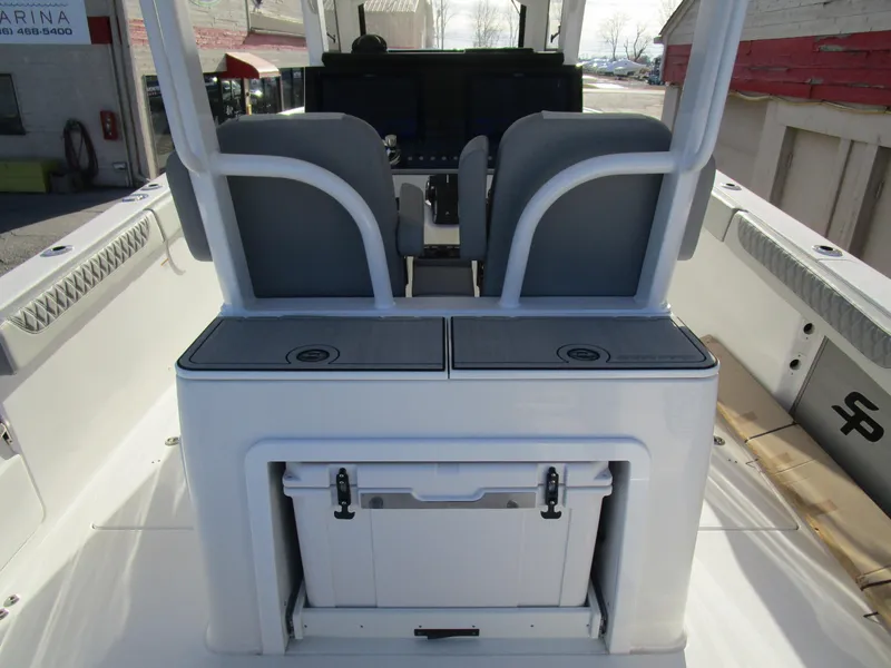 Slide: The Image of 2024 Sea Pro 322 Offshore boat interior with dual seats and storage compartments. - 14