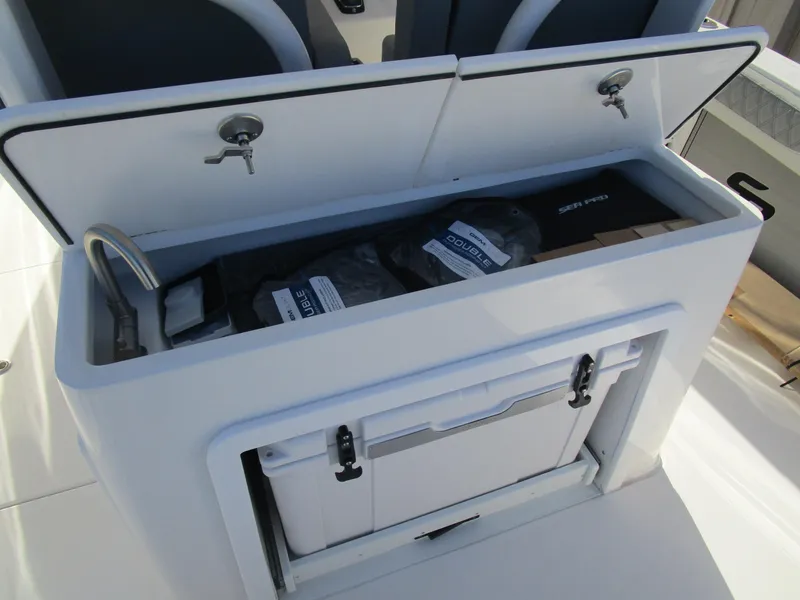 Slide: The Image of 2024 Sea Pro 322 Offshore storage compartment with cooler and gear. - 15