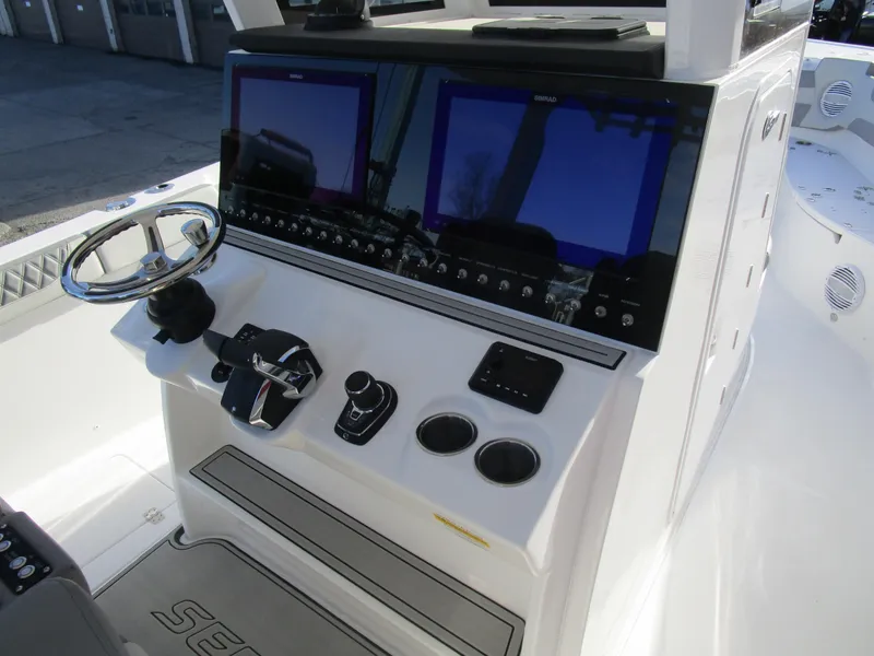 Slide: The Image of 2024 Sea Pro 322 Offshore boat console with dual screens and controls. - 18