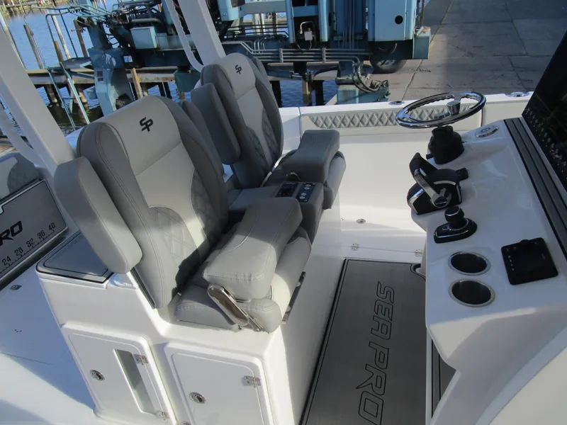 Slide: The Image of 2024 Sea Pro 322 Offshore boat interior with dual captain's chairs and control console. - 20