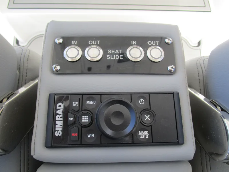 Slide: The Image of 2024 Sea Pro 322 Offshore seat slide controls and Simrad navigation system. - 21