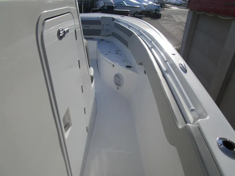 Slide: The Image of 2024 Sea Pro 322 Offshore boat deck with storage compartments and seating. - 27