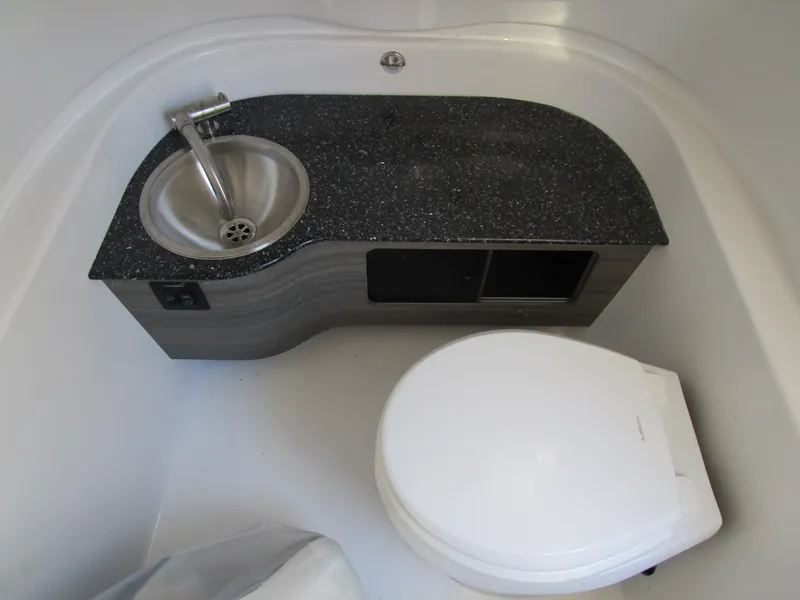 Slide: The Image of 2024 Sea Pro 322 Offshore boat bathroom with sink and toilet. - 29
