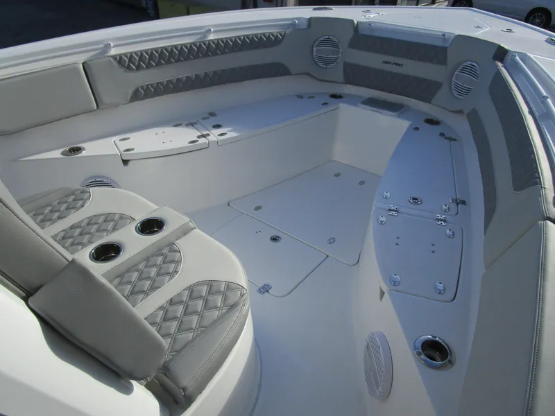 Slide: The Image of 2024 Sea Pro 322 Offshore boat interior with cushioned seating and storage compartments. - 30