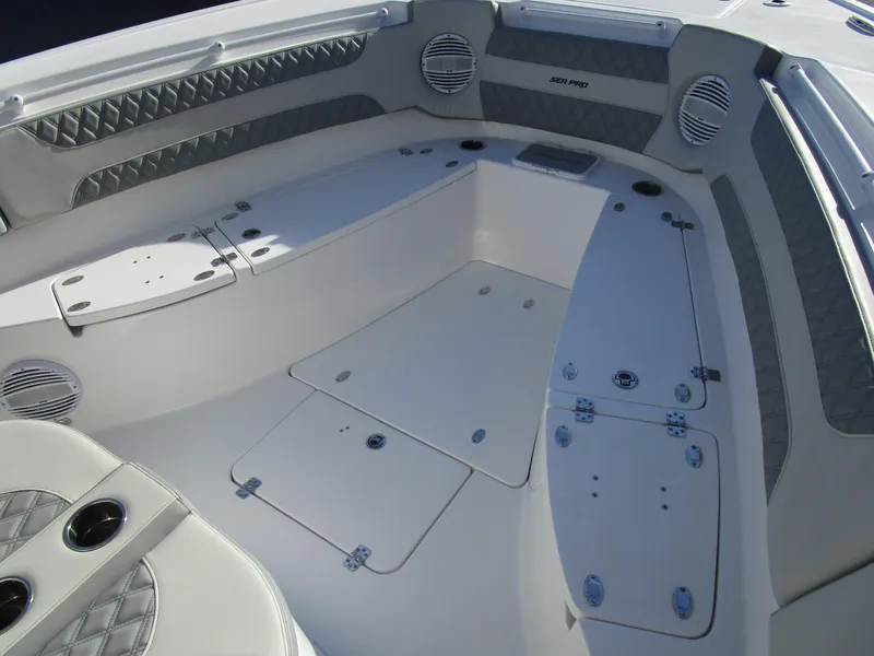 Slide: The Image of 2024 Sea Pro 322 Offshore boat interior with seating and storage compartments. - 32