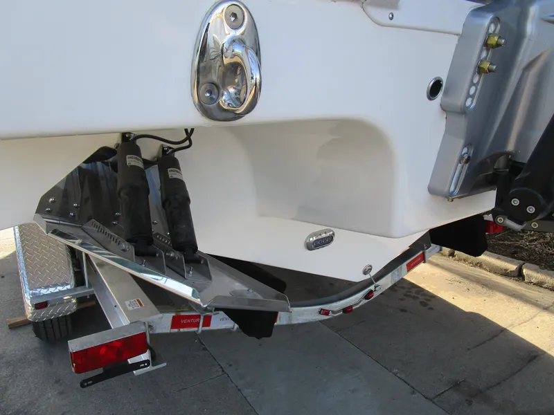 Slide: The Image of 2024 Sea Pro 322 Offshore boat on trailer, close-up of stern and trim tabs. - 6