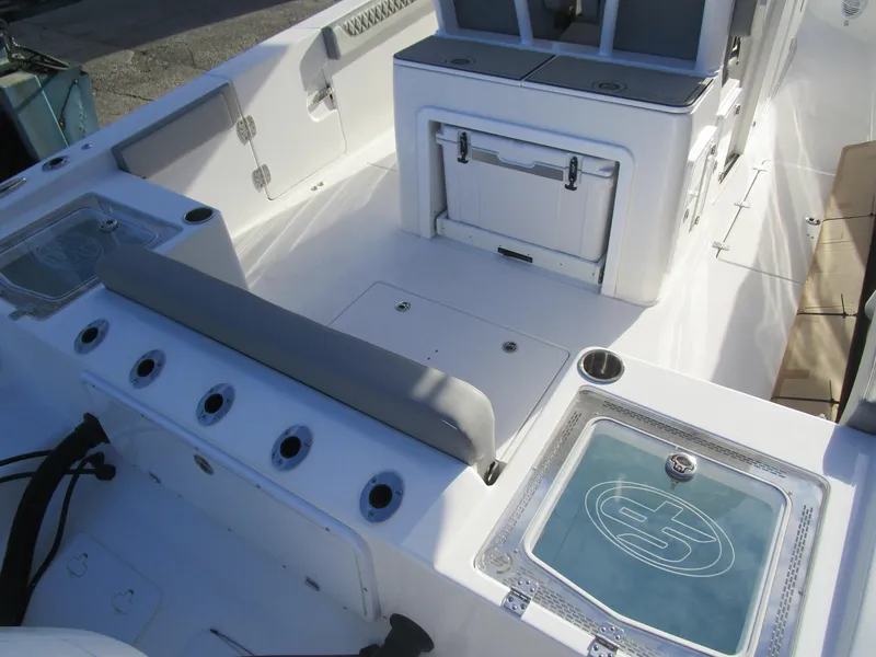 Slide: The Image of 2024 Sea Pro 322 Offshore boat interior with seating and storage compartments. - 9